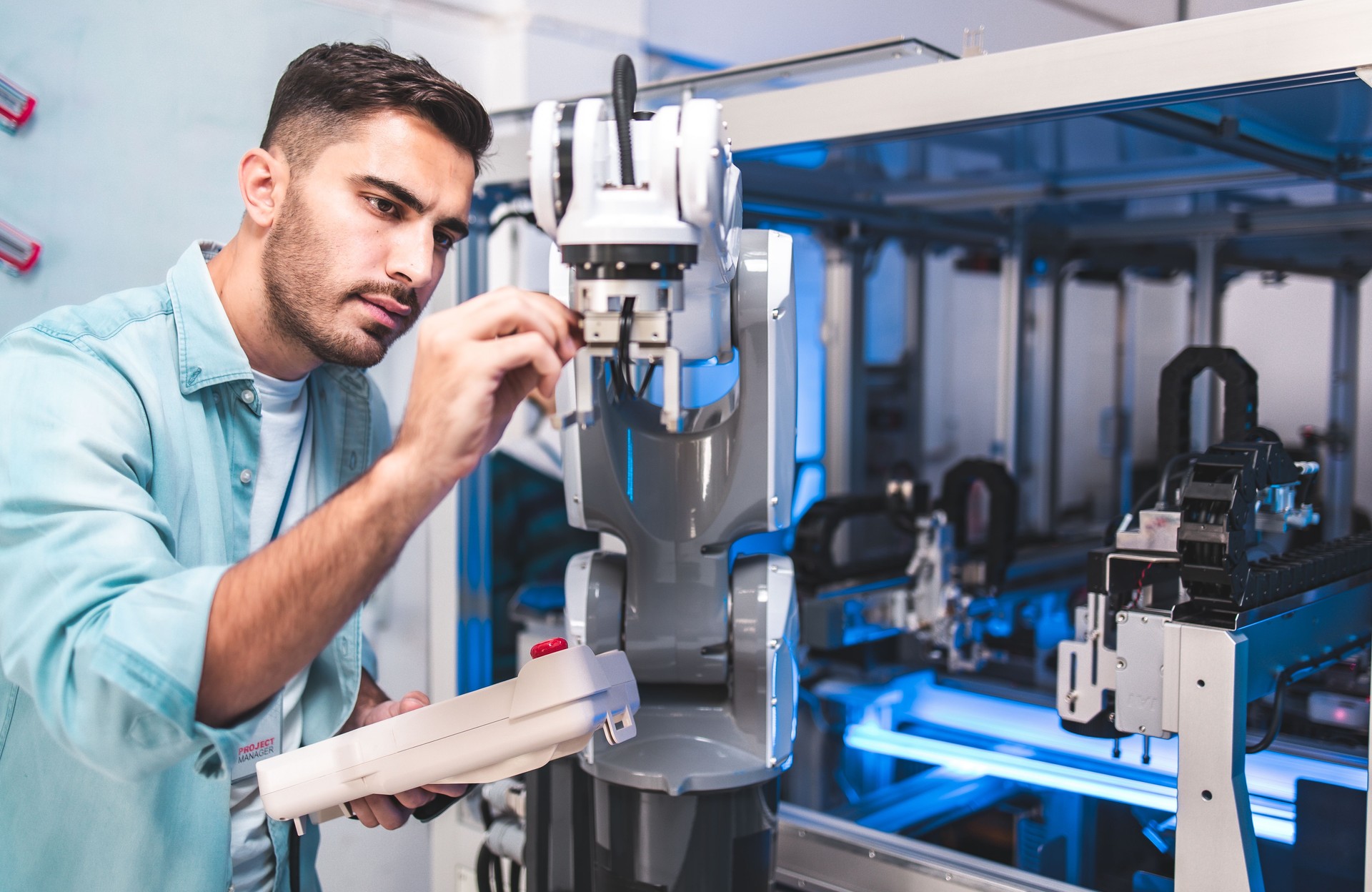Team of engineers are conducting an experiment with robots.Close Up of a Futuristic Prosthetic Robot Arm Being Tested by a Professional Development Engineer